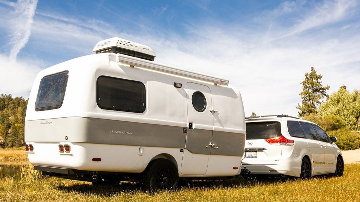A top-rated travel trailer parked in a scenic outdoor setting, showcasing its modern design and features, perfect for RV enthusiasts seeking adventure and comfort